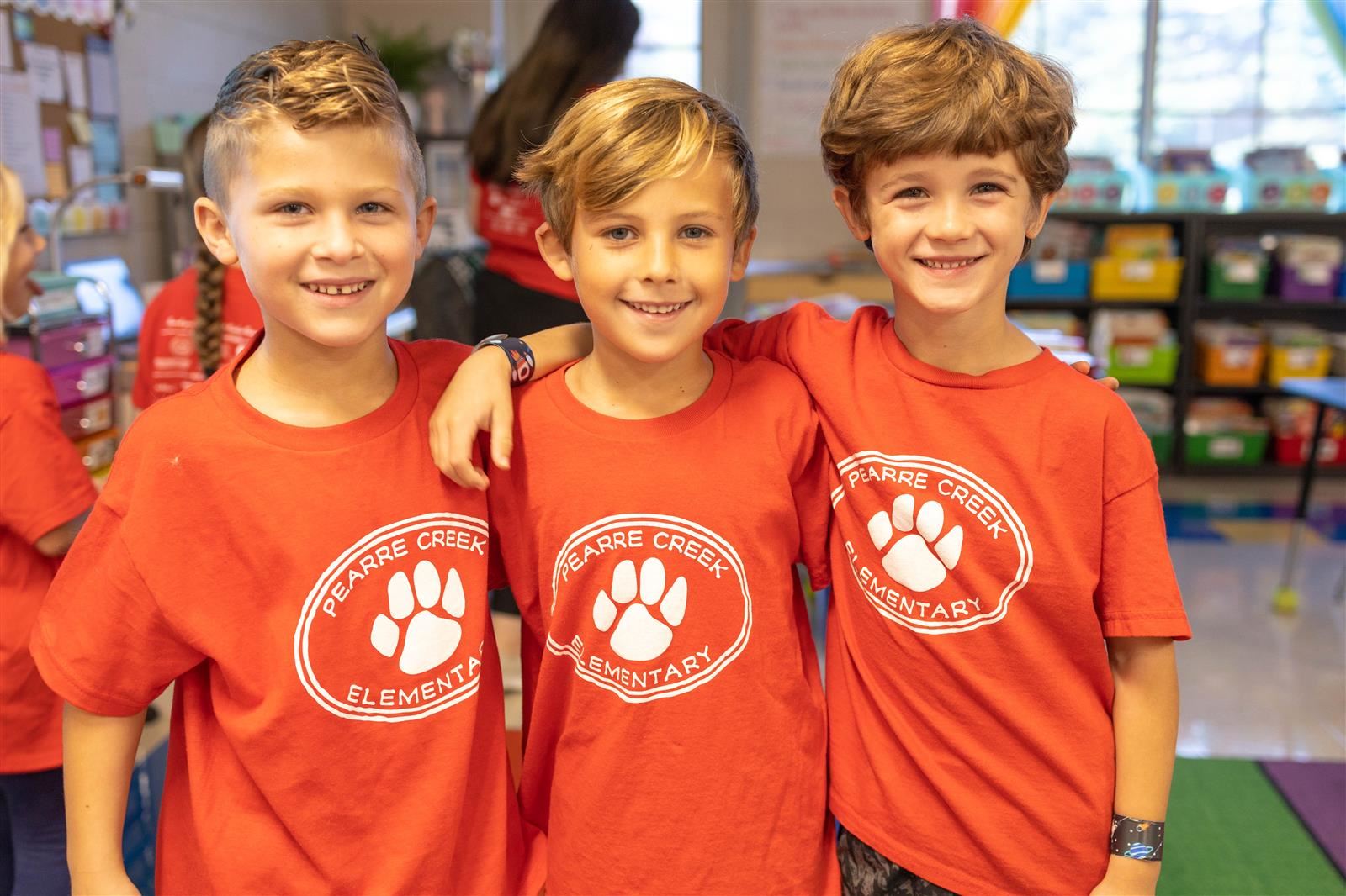 Three boys with red shirts on